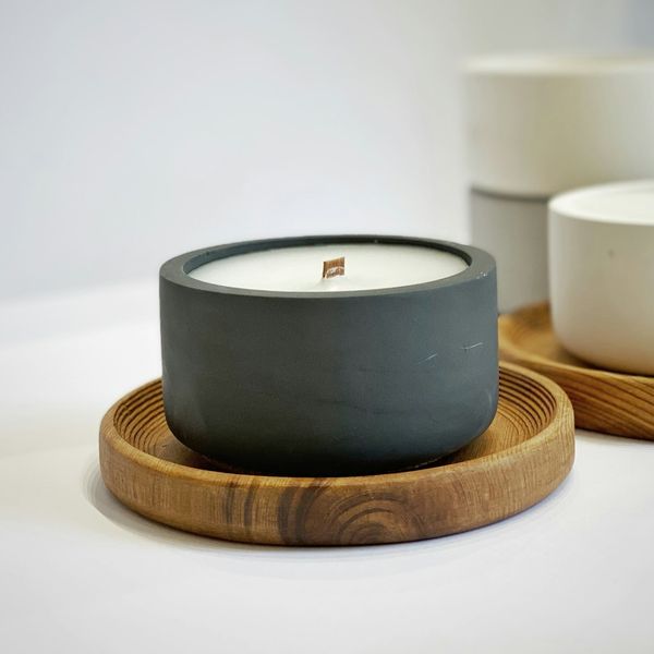 A concrete candle on a wooden tray