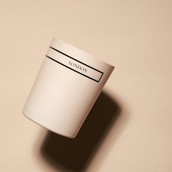 A cream candle in a ceramic holder