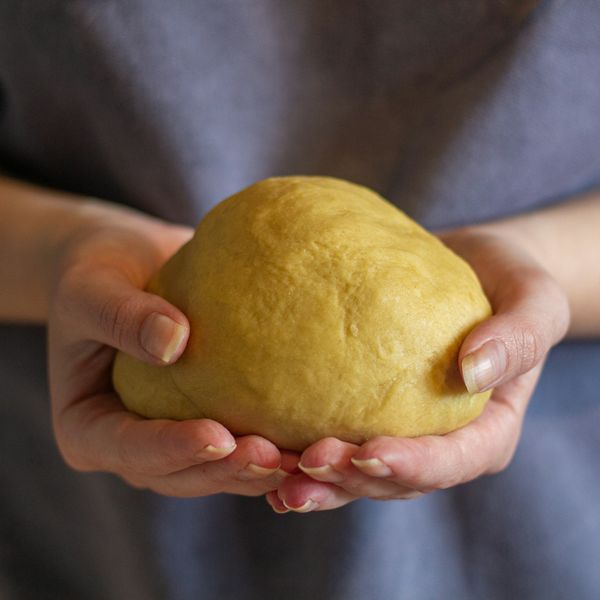 Hands holding fresh dough