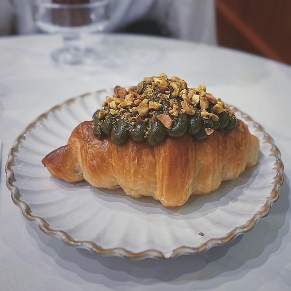 A pistachio croissant on a plate